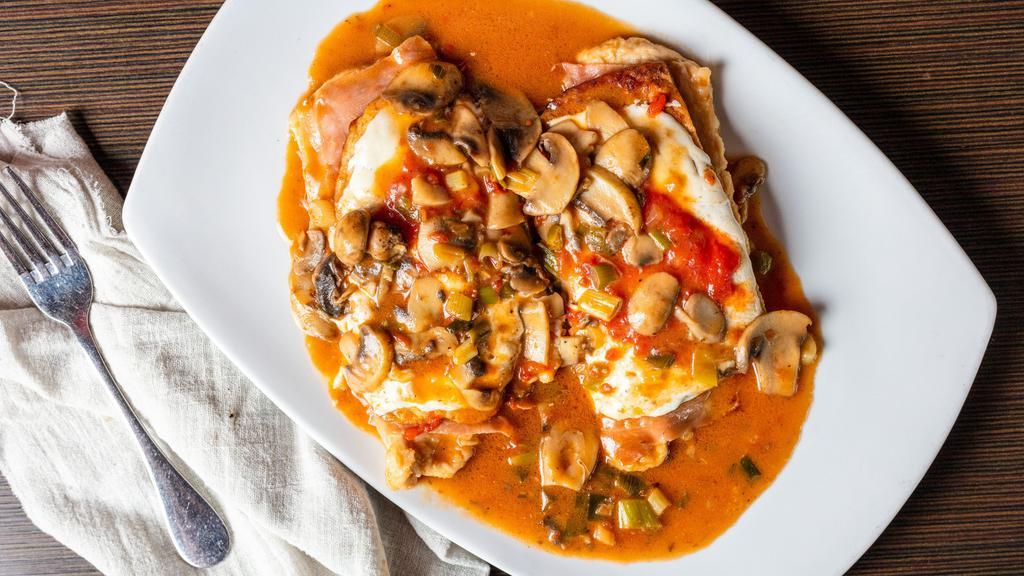 Sorrentino · Fresh breast of chicken or veal layered with battered eggplant, mozzarella cheese and imported prosciutto di Parma served in a mushroom brown sauce.