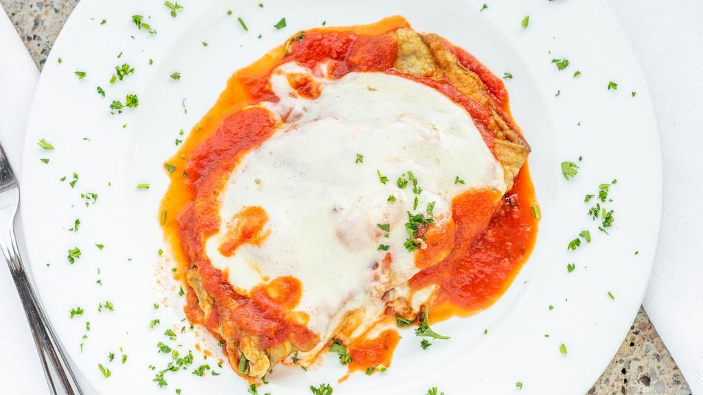 Eggplant Parmigiana · Eggplant baked in tomato sauce, melted mozzarella, grated cheese. Served with side of penne or spaghetti marinara or side salad.