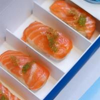 Salmon Crispy Rice · 4 pieces of sliced salmon with ponzu sauce, green tobiko + dicon atop air fried crispy rice