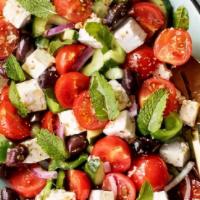 Greek Salad · Mixed greens, cucumbers, tomatoes, Feta cheese, and olives.