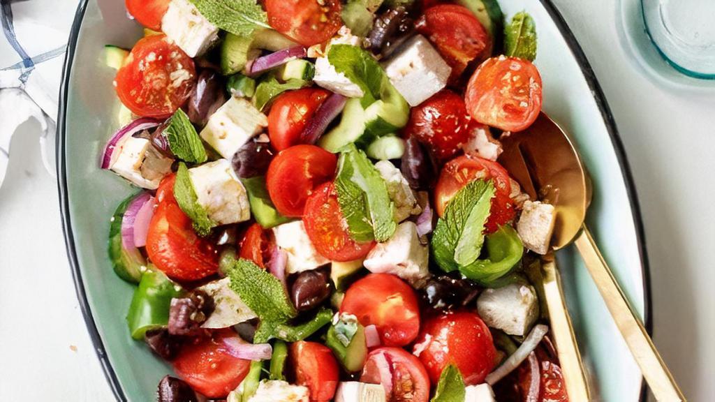 Greek Salad · Mixed greens, cucumbers, tomatoes, Feta cheese, and olives.