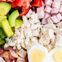 Cobb Salad · Mixed greens, sliced hard boil egg, Cheddar cheese, chopped bacon, and olives.