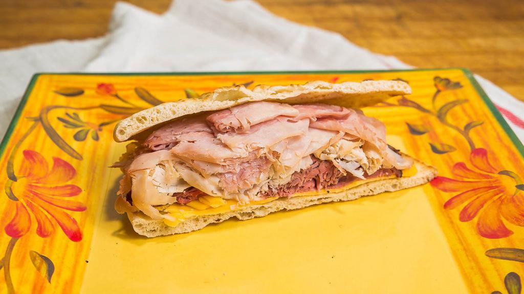 The Benz Sandwich · Ham, turkey, roast beef and American cheese. Includes a pickle and a side salad.