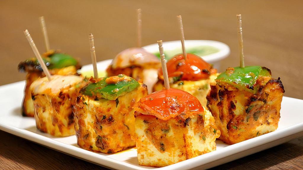 Paneer Shashlik · Marinated cubes of fresh cottage cheese, bell peppers and onions finished in tandoor.