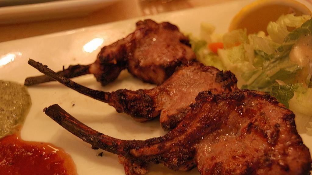 Tandoori Lamb Chops · Tender lamb chops marinated with herbs and spices finished to perfection in tandoor.