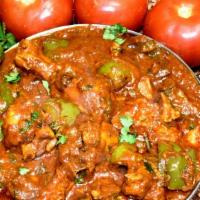 Chicken Kadai · Chicken tenders tossed with diced onions, tomatoes, bell peppers and light brown gravy.