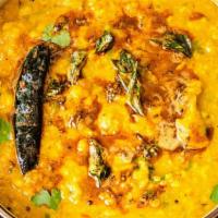 Yellow Dal Tadka · Yellow lentils cooked with tomatoes, turmeric, ginger, chilies and jeera tadka, chopped cori...