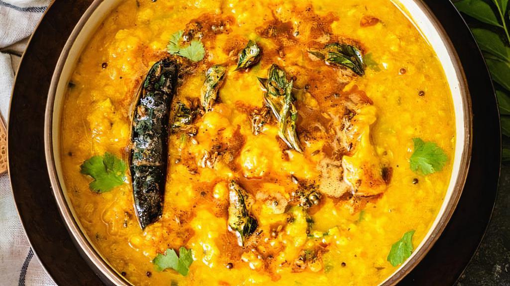 Yellow Dal Tadka · Yellow lentils cooked with tomatoes, turmeric, ginger, chilies and jeera tadka, chopped coriander.