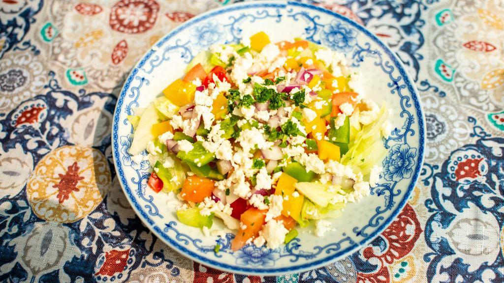 Greek Salad · Romaine lettuce, olives, tomatoes, onions, peppers & cucumbers. Dressed w/ Olive Oil, a Splash of White Wine Vinegar & finished w/ Crumbled Feta Cheese.