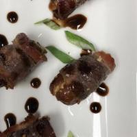 Bacon Wrapped Dates · Dates, smoked almonds and bacon topped with a balsamic reduction.