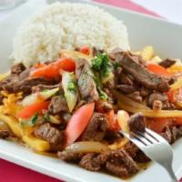 Lomo Saltado · Our most requested meat dish. Strips of pepper steak sauteed with onions, tomatoes and our s...