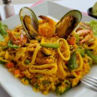 Arroz Con Mariscos · Peruvian style paella. Includes delicious baby shrimps, mussels, octopus, crab, calamari. Co...