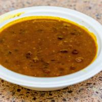 Daal · Lentils submerged over a low flame, laced with herbal cream, delicately flavored with spices.