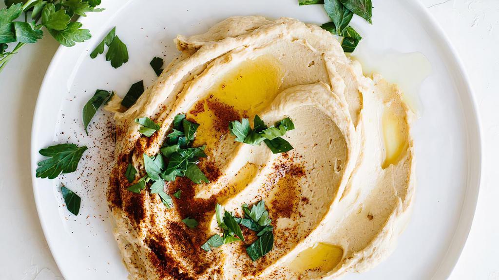 Traditional Hummus · Chickpeas, garlic, lemon, tahini. Served with mixed pickles. +$2 for cucumbers and carrots. GF, vegetarian, vegan