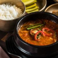 Kimchi Stew · Very few things are simultaneously comforting and invigorating, but this tart and spicy stew...