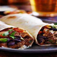 Carne Asada Burrito · Juicy steak, sauteed peppers, onions, tomatoes, Spanish rice, beans, and cilantro wrapped in...