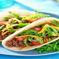 Ground Beef Taco · Flavorful ground beef, sauteed peppers, onions, tomatoes, and cilantro wrapped in a warm cor...
