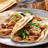 Chicken Taco · Marinated grilled chicken, sauteed peppers, onions, tomatoes, and cilantro folded in a warm ...
