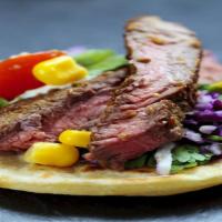 Steak Fajita · Grilled steak prepared with peppers and onions and served with Spanish rice and choice of si...