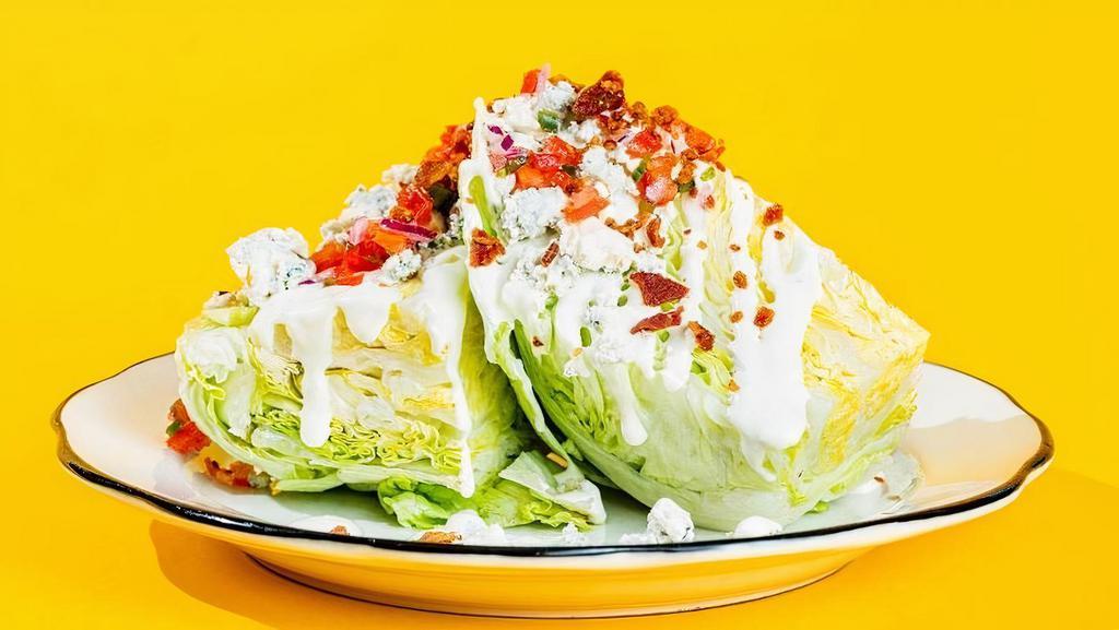 The Wedge Salad · Iceberg lettuce, blue cheese crumble, tomato-jalapeno salsa, blue cheese sauce, applewood smoked bacon bits
