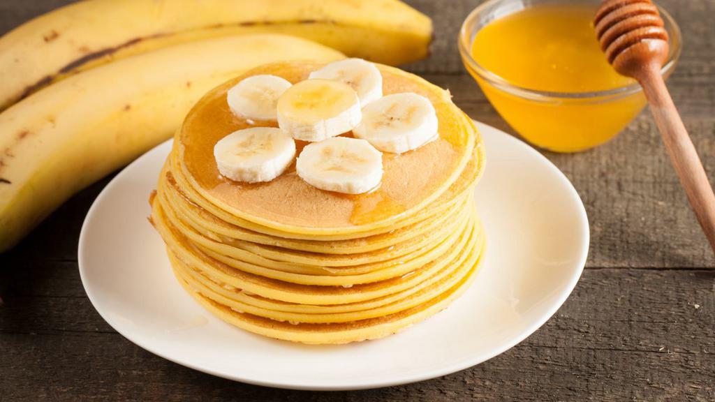 Banana Pancakes · Fluffy, golden, buttery buttermilk pancakes loaded with fresh bananas. Served with real butter and maple syrup.