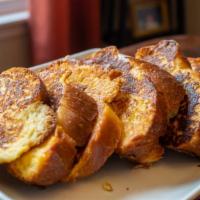 Challah French Toast · Thick slices of challah bread, soaked in a rich, eggy mixture and griddle to golden perfecti...