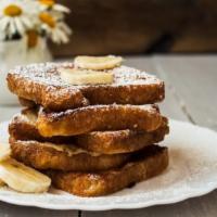 Banana French Toast · Thick slices of bread, soaked in a rich, eggy mixture and griddle to golden perfection. Topp...