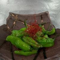 Blistered Shishito Peppers · Vegan. Shishito peppers that are roasted with garlic aioli sauce topped with red chili peppe...