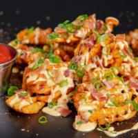 Loaded Waffle Fries · Waffle fries seasoned in Sam's New Orleans style spice, topped with Cheese Sauce, Bacon Crum...
