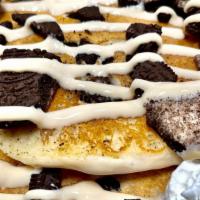 Oreo Pancakes · Stack of Oreo filled Pancakes topped with crumbled oreos and vanilla cream