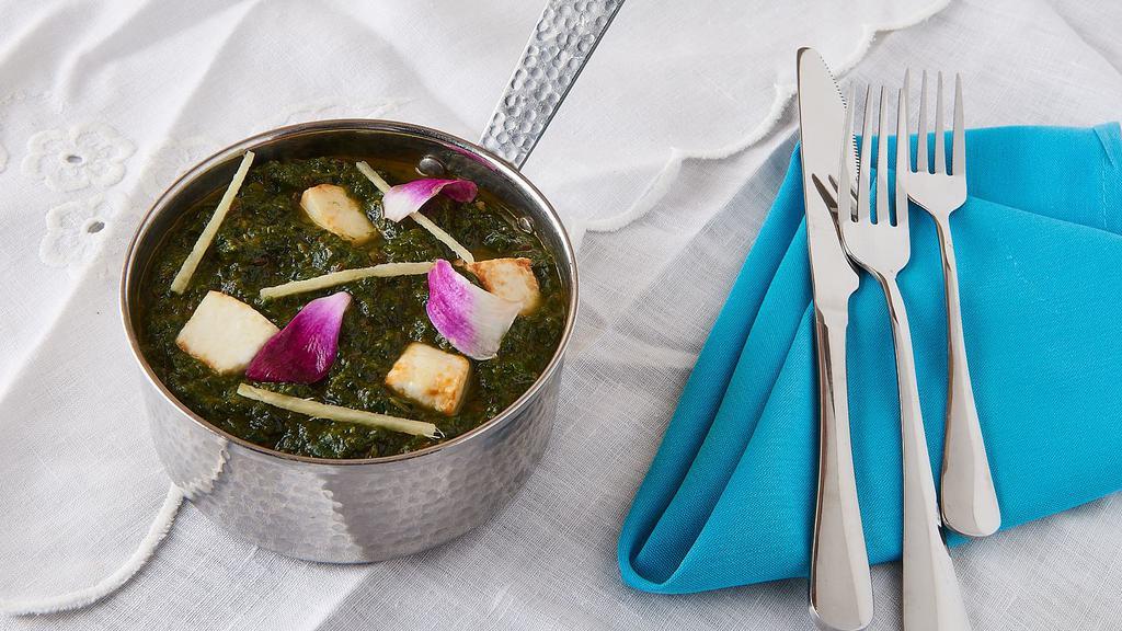 Palak Paneer · Fresh creamed spinach cooked with cubes of homemade cottage cheese.