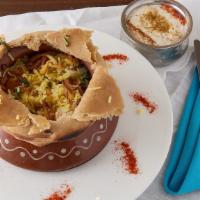 Dum Pukht Chicken Biryani · Aromatic basmati rice cooked with flavorful chicken. (served with raita)