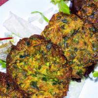 Mucver · Zucchini pancake. Mashed zucchini blended with herbs and fried till golden brown.