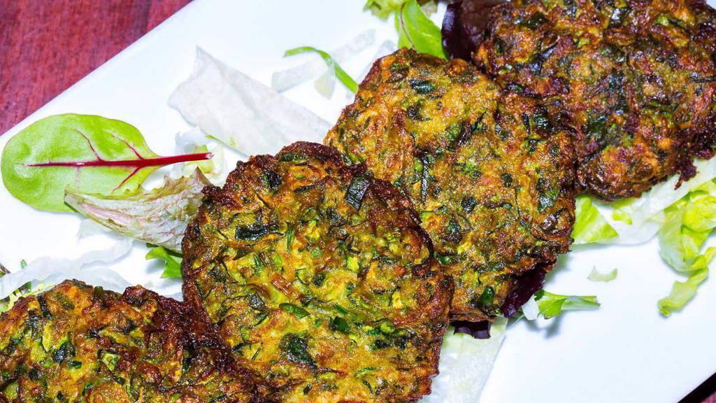 Mucver · Zucchini pancake. Mashed zucchini blended with herbs and fried till golden brown.
