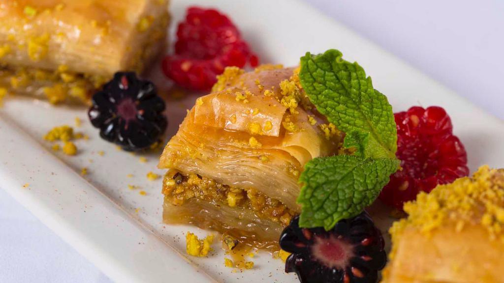 Baklava · Sweet pastry made of extremely thin sheets of phyllo dough layered with chopped nuts and honey syrup and baked with butter.