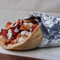 Halal Lamb Gyro Sandwich · Juicy halal lamb gyro, salad, house-made white sauce, and hot sauce served in warm pita brea...