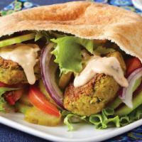 The Falafel Sandwich Meal · Crispy falafels, salad, house-made white sauce, and hot sauce served in warm pita bread. Add...