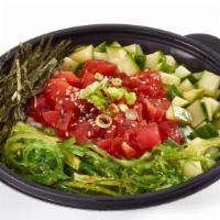 Tuna Poke Bowl · 520 calories. Soy marinated tuna (raw) poke bowl with fresh vegetables and sauce on top of a...