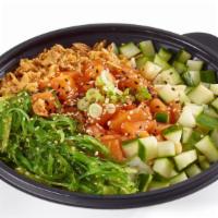 Salmon Poke Bowl · 670 calories. Soy marinated salmon (raw) poke bowl with fresh vegetables and sauce on top of...