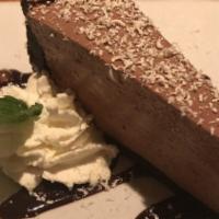 Chocolate Mousse Cake · White chocolate shavings, whipped cream, chocolate sauce.