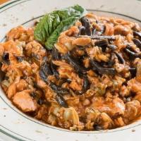 Squid Ink Linguini · Seafood ragú  chopped Baby clams oil cured tuna  tomato chili