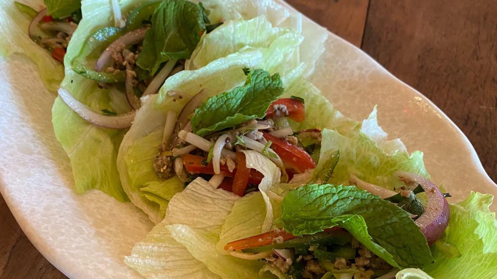 Chicken Laap · Minced Chicken, Bell Peppers, Bean Sprouts and Red Onion Tossed Cold in a Fish and Lime Sauce. Garnished with Mint, Accompanied with Lettuce to be Enjoyed as a Lettuce Wrap.