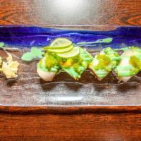 Yoshi Roll · Crunchy spicy tuna inside topped with white tuna avocado and green tobiko on top with.wasabi...