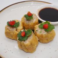 Steamed Dumpling · Wonton skin stuffed with shrimp, chicken, crabmeat served with garlic black soy sauce.