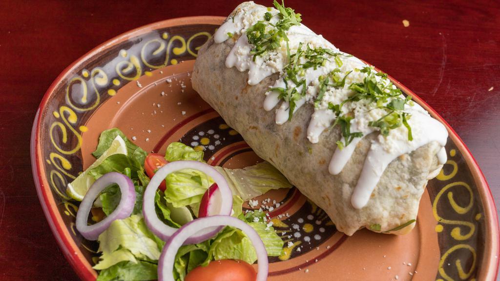 Chicken Burrito · Flour tortilla stuffed with rice, beans, tomato, onions and cilantro. Topped with sour cream and cheese.