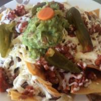 Regular Nachos · Tortilla chips topped with refried beans, melted cheese, onion, cilantro, tomato, sour cream...