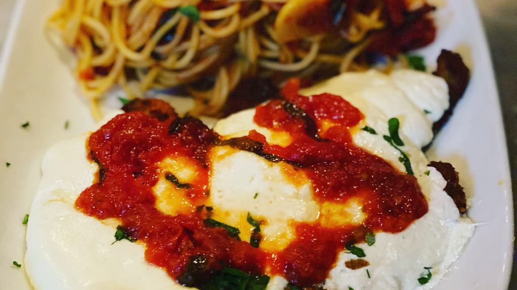 Chicken Parmigiana · Fried breaded chicken covered in Marinara sauce and melted Mozzarella over Spaghetti