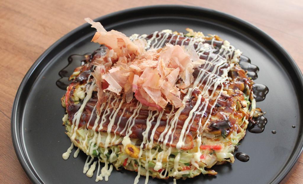 Classic-O · Japanese vegetable pancake with, pork belly, bonito flakes with Okonomiyaki sauce with Japanese mayo.