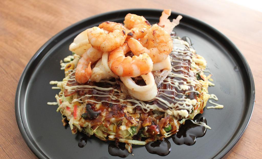 Deluxe Seafood-O · Japanese vegetable pancake with  pork belly, bonito flakes with Okonomiyaki Sauce with Japanese mayo, squid and shrimp.