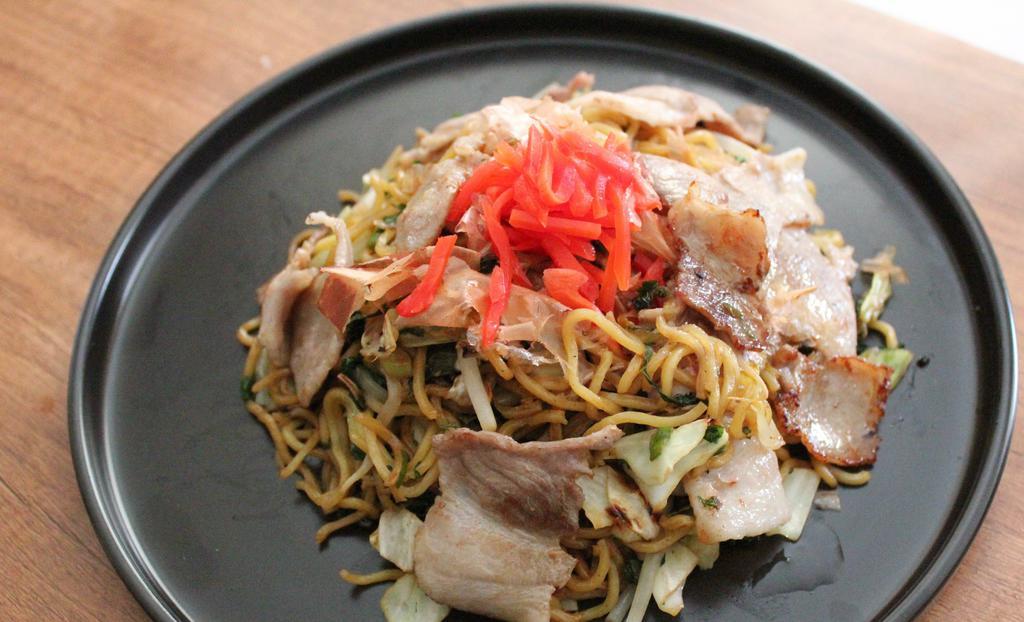 Yakisoba With Pork · Japanese stir fry noodles with vegetable and pork topped with bonito flakes and pickled ginger.